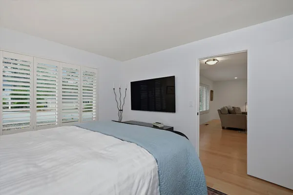 a bedroom with a bed and a flat screen tv