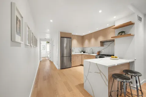 a kitchen with a sink a refrigerator and a stove top oven