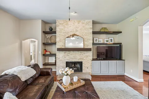 a living room with furniture and a fireplace