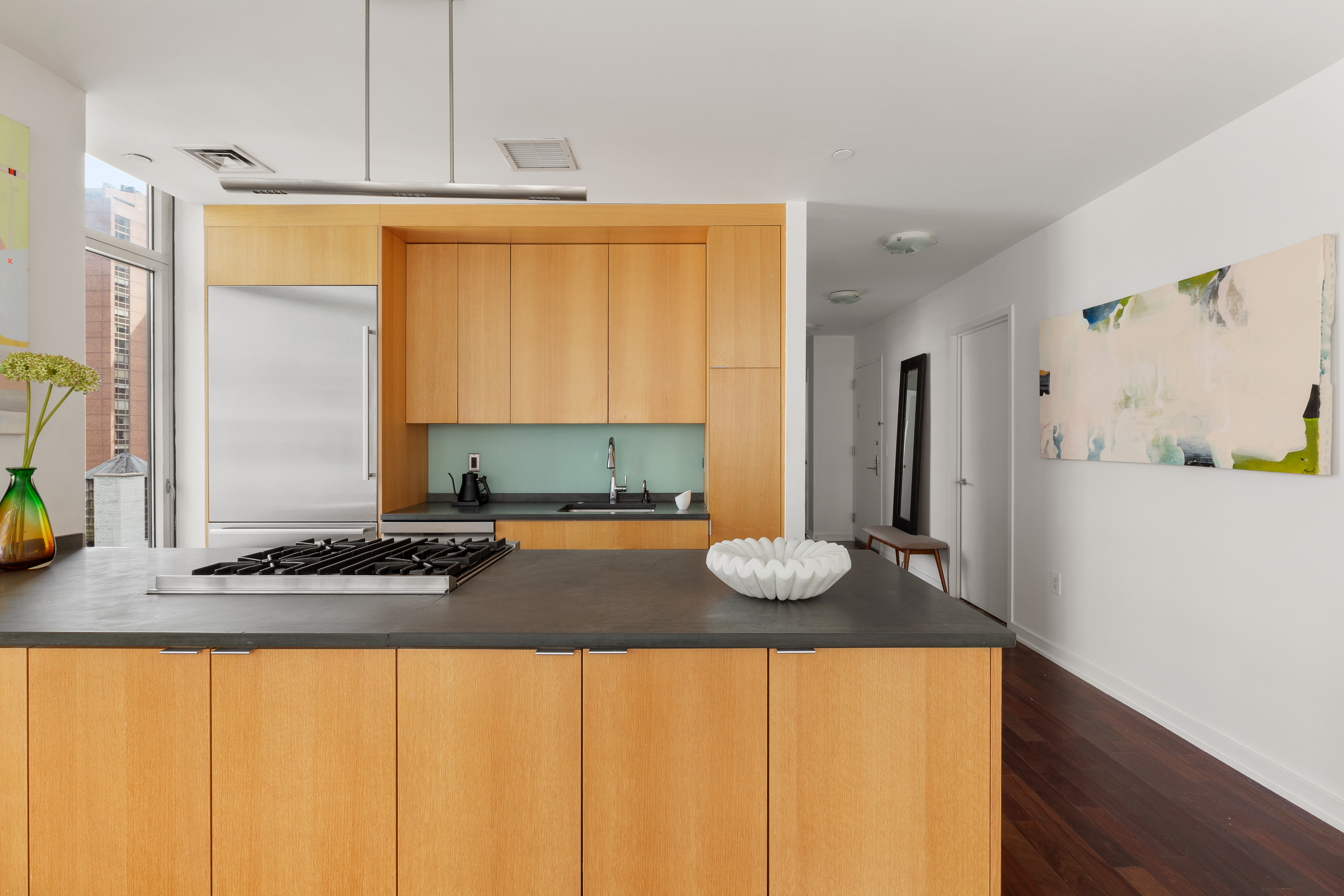 207 East 57th Street, Unit 18A Manhattan, NY 10022 - Photo 3 of 10 a kitchen with a sink and a stove top oven