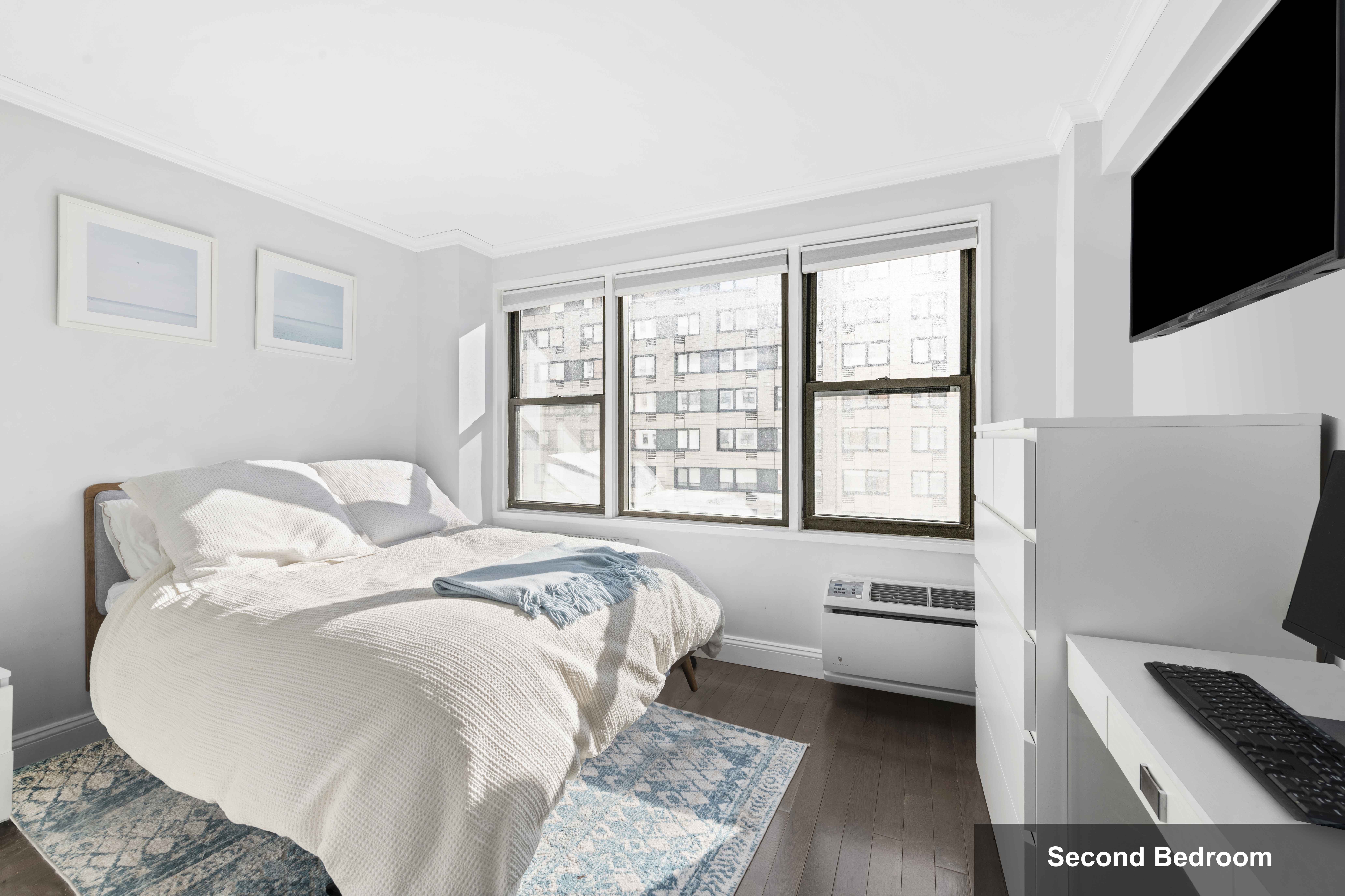 333 East 34th Street, Unit 10H Manhattan, NY 10016 - Photo 8 of 16 a living room with furniture and a flat screen tv