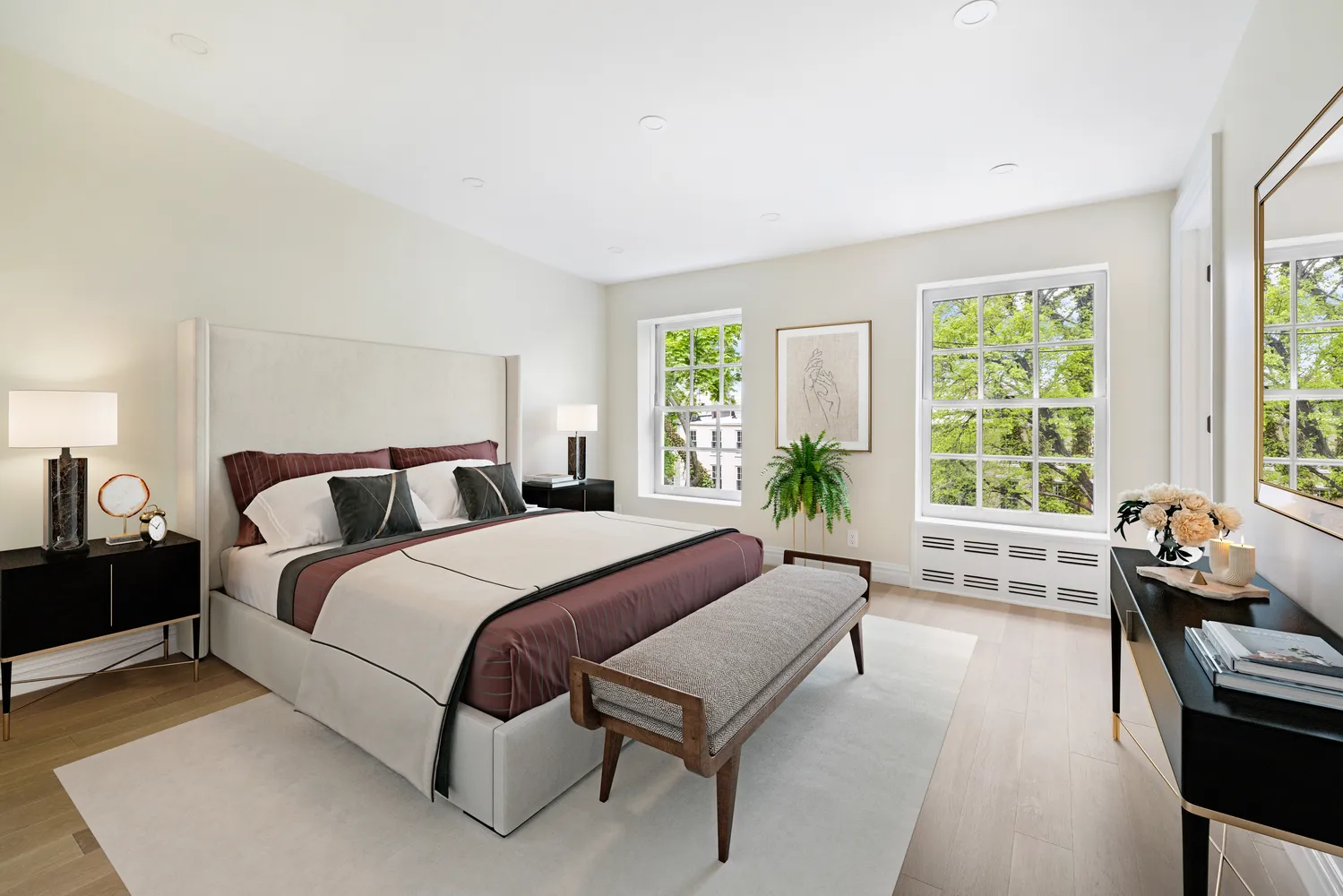 a spacious bedroom with a bed and a couch next to a window