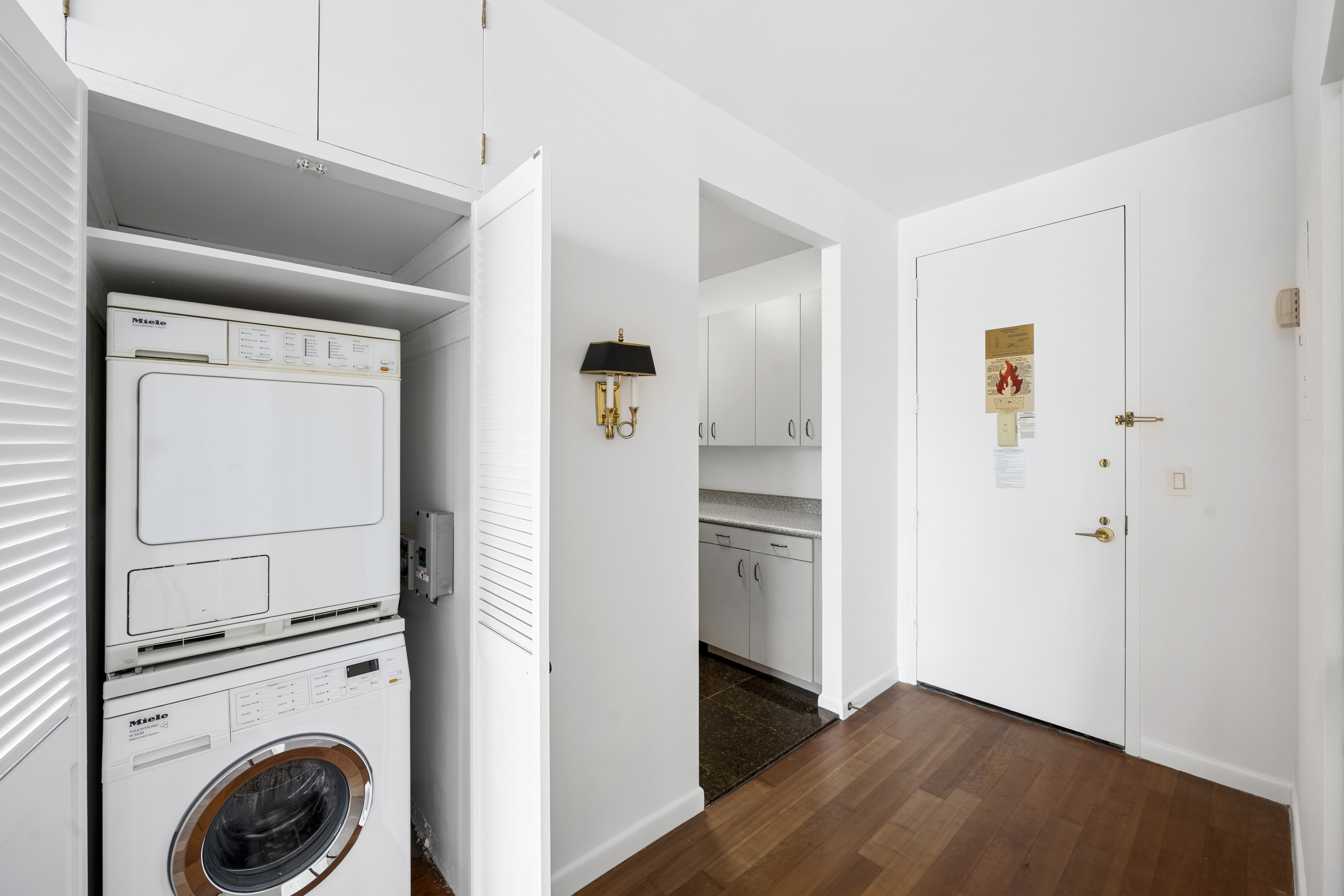 111 West 67th Street, Unit 22B Manhattan, NY 10023 - Photo 3 of 10 a view of a hallway with washer and dryer