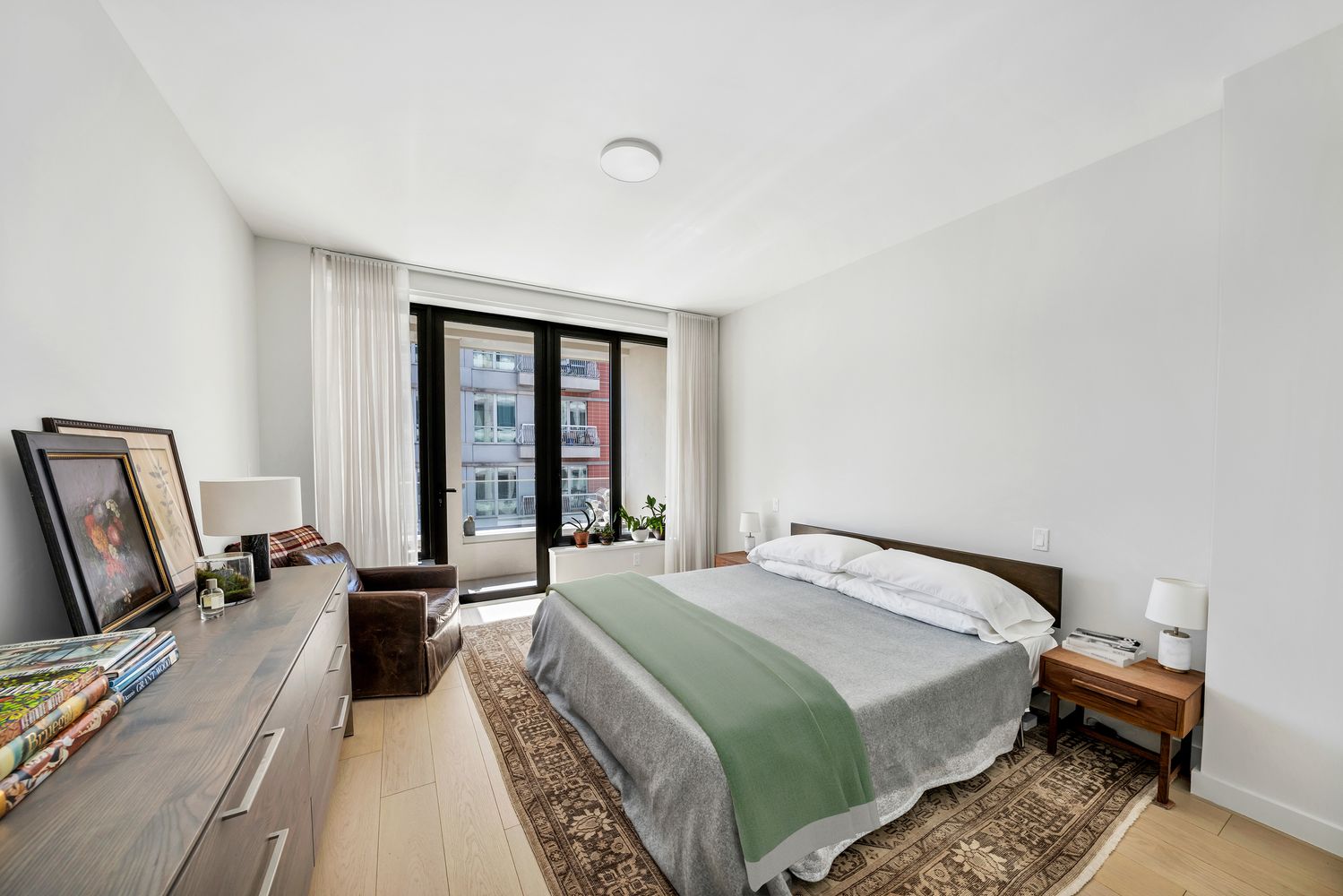 a bed room with a bed window and a television