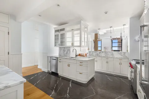 a kitchen with sink cabinets and window