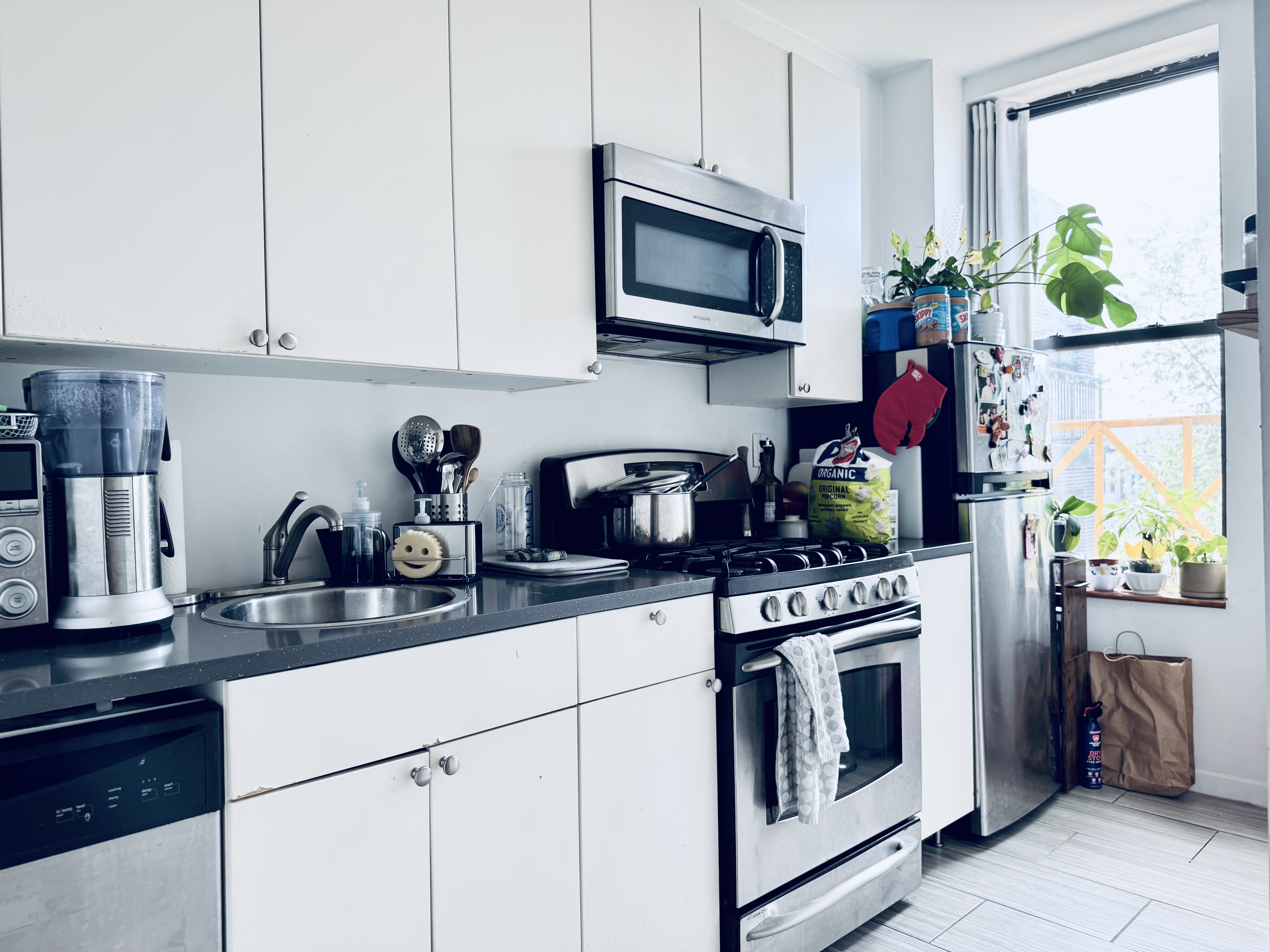 540 4th Avenue, Unit 3 Brooklyn, NY 11215 - Photo 7 of 8 a kitchen with stainless steel appliances granite countertop white cabinets a stove top oven a sink and dishwasher