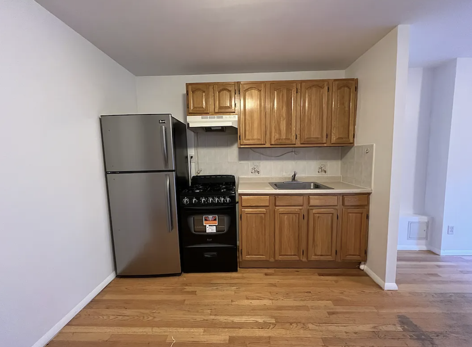 446 West 46th Street, Unit 12 Manhattan, NY 10036 - Photo 2 of 18 a kitchen with a refrigerator and a stove