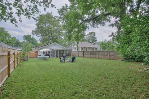 a view of a house with backyard and porch