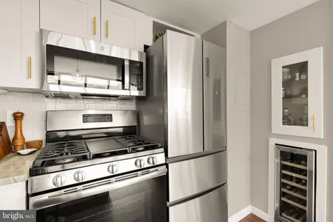 a kitchen with stainless steel appliances granite countertop a refrigerator stove and sink