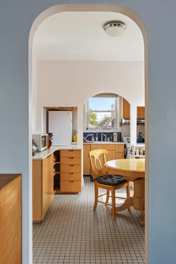 a kitchen with cabinets and wooden floor