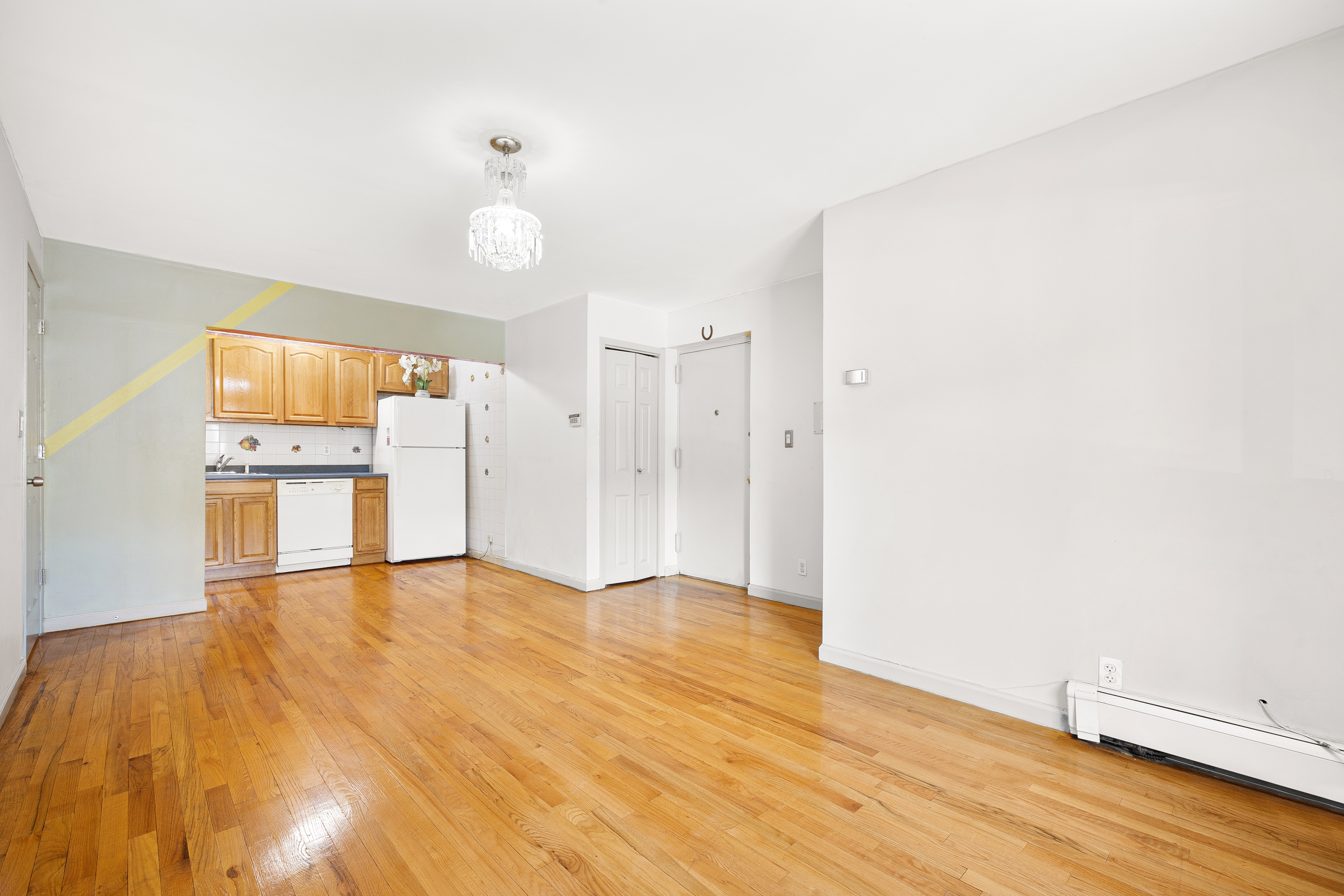 41-26 71st Street, Unit 1A Queens, NY 11377 - Photo 4 of 11 a view of empty room with wooden floor and window
