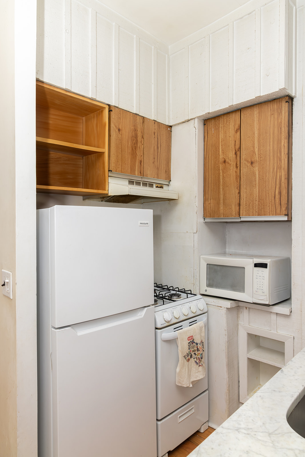 147 Sullivan Street, Unit 2A Manhattan, NY 10012 - Photo 6 of 8 a kitchen with stainless steel appliances white cabinets and a refrigerator