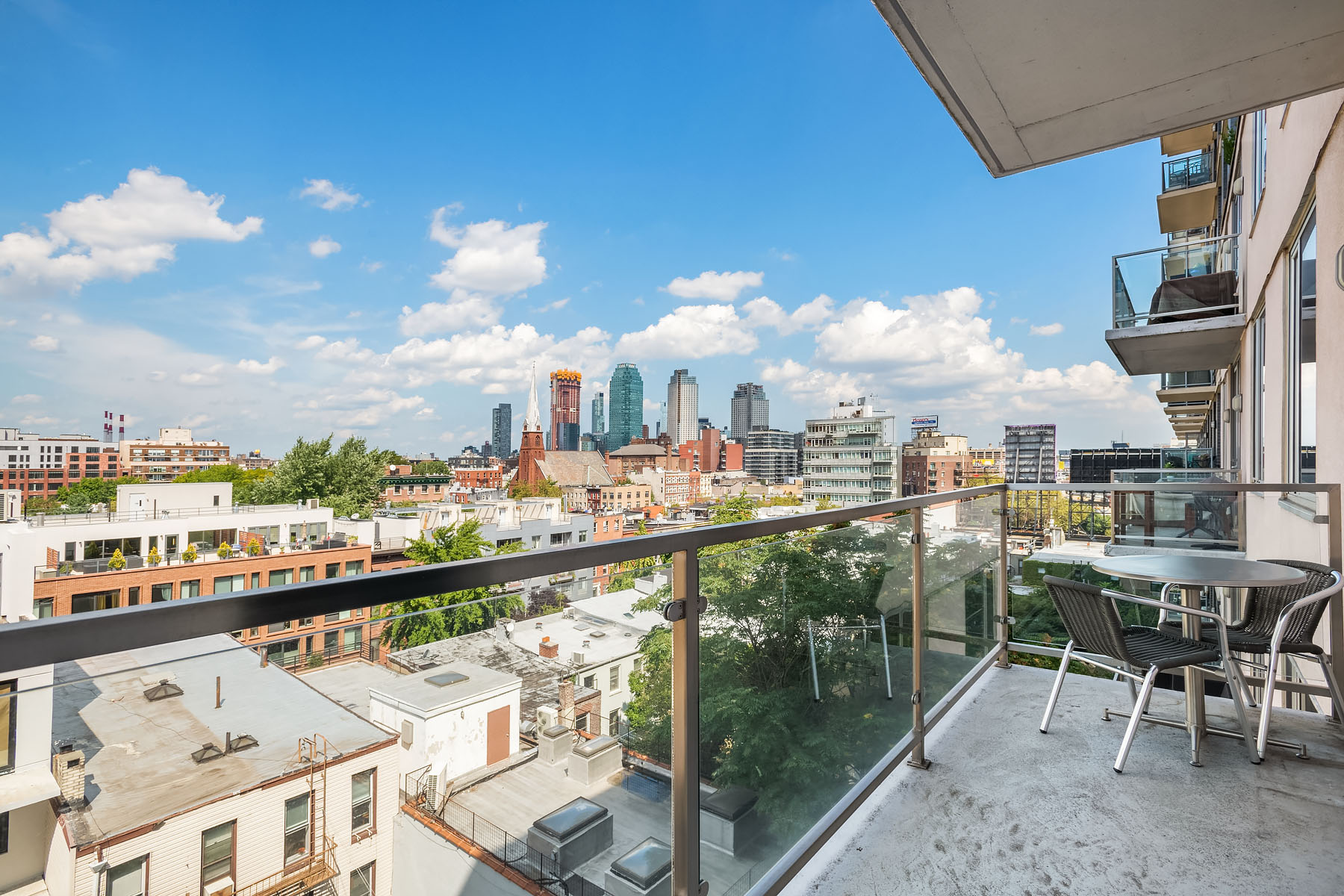 5-19 Borden Avenue, Unit 6C Queens, NY 11101 - Photo 4 of 11 a view of a balcony with a table and chairs