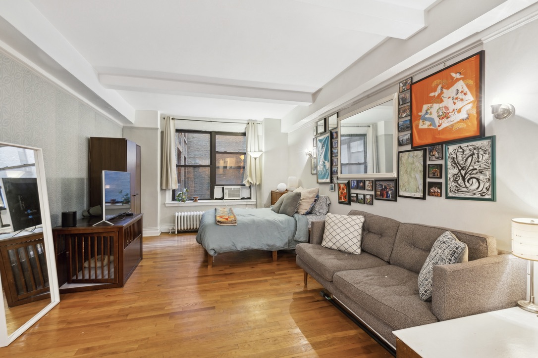 235 West 102nd Street, Unit 8A Manhattan, NY 10025 - Photo 1 of 5 a living room with furniture and a flat screen tv