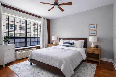 a bedroom with a large bed and a window