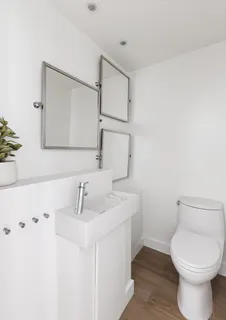 a bathroom with a toilet sink and mirror