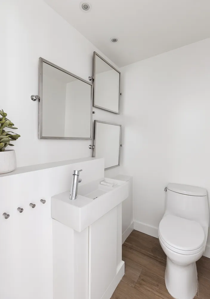 a bathroom with a toilet sink and mirror