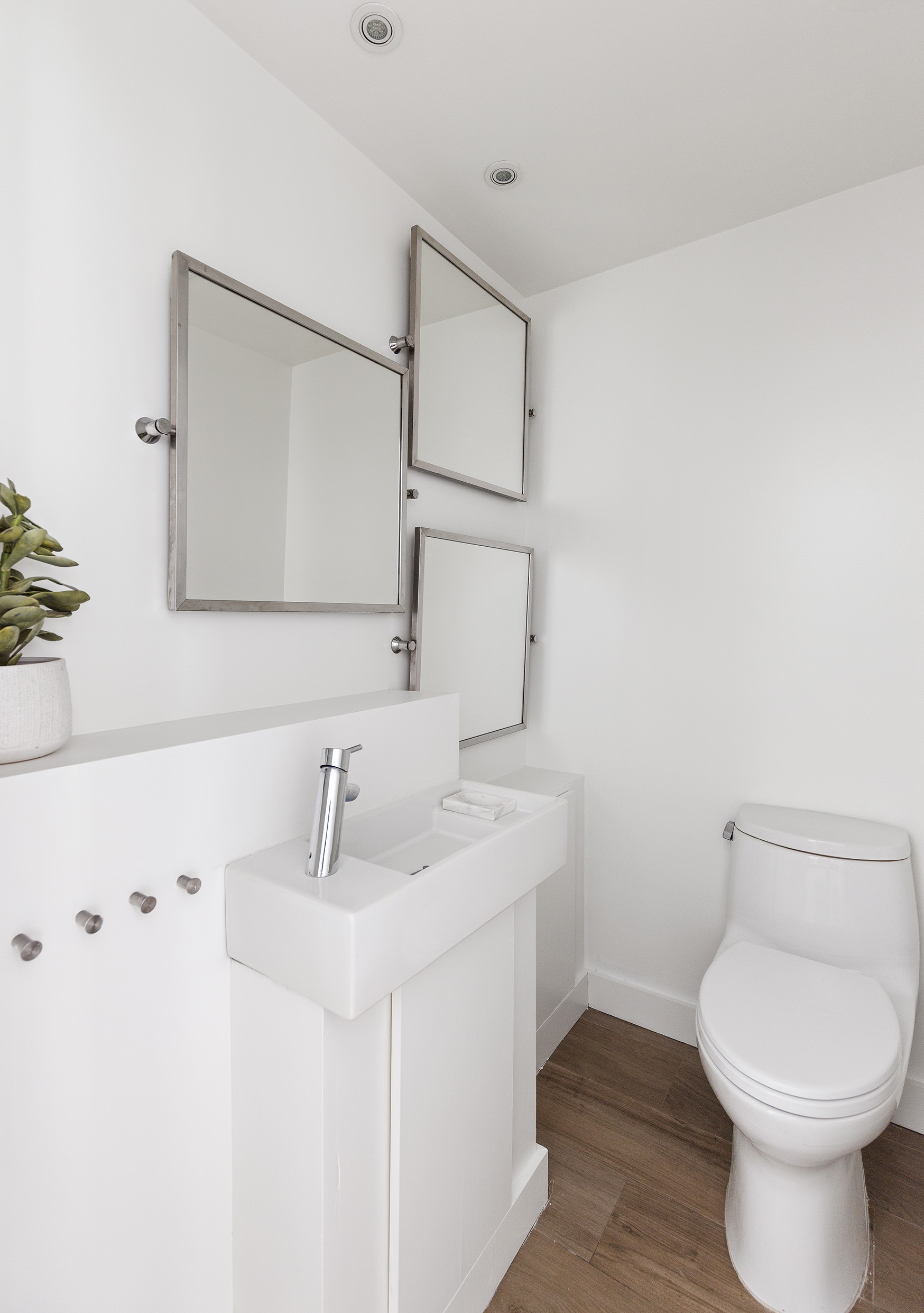 340 East 64th Street, Unit 19L Manhattan, NY 10065 - Photo 15 of 17 a bathroom with a toilet sink and mirror
