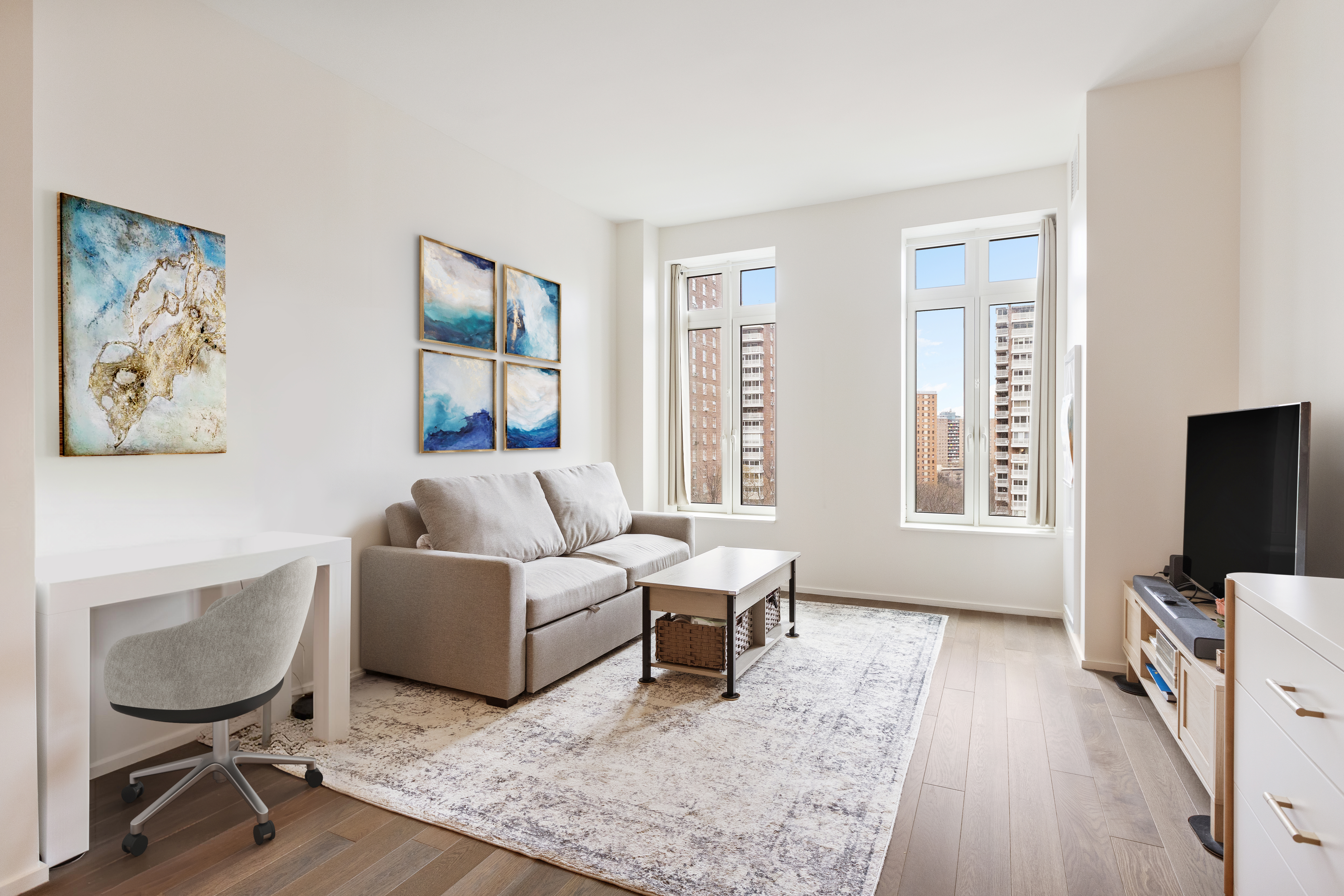 a living room with furniture a flat screen tv and a window