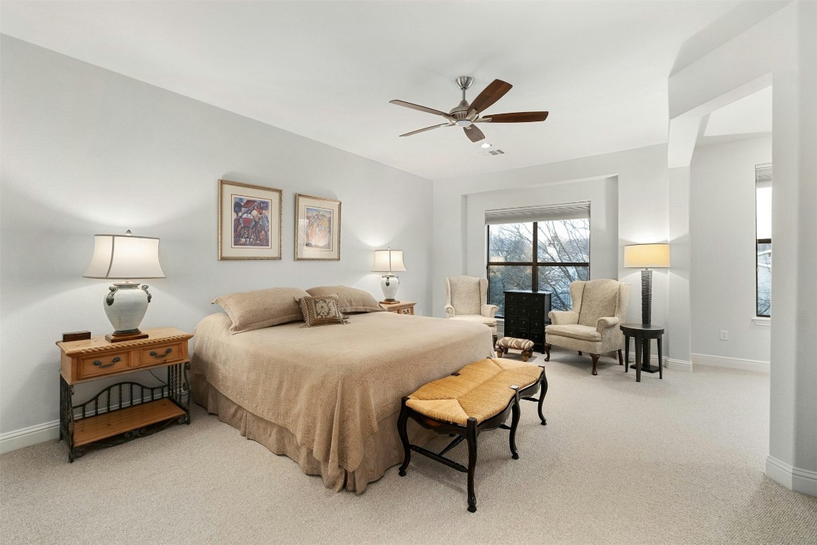 2505 Enfield Road, Unit 4 Austin, TX 78703 - Photo 10 of 19 a bedroom with a bed and a chandelier