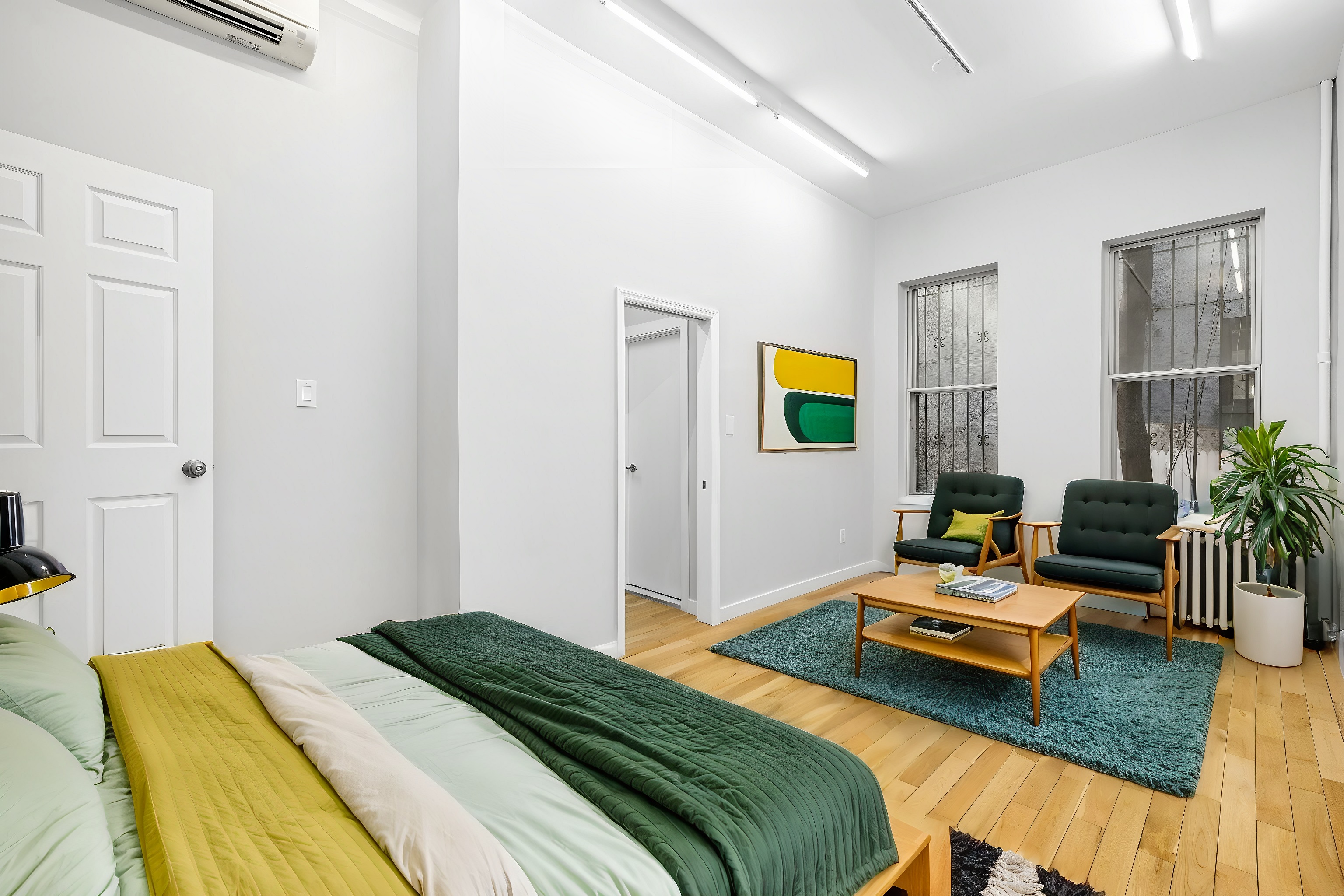 249 East Houston Street, Unit PARLOR Manhattan, NY 10002 - Photo 7 of 12 a bedroom with bed and a couch