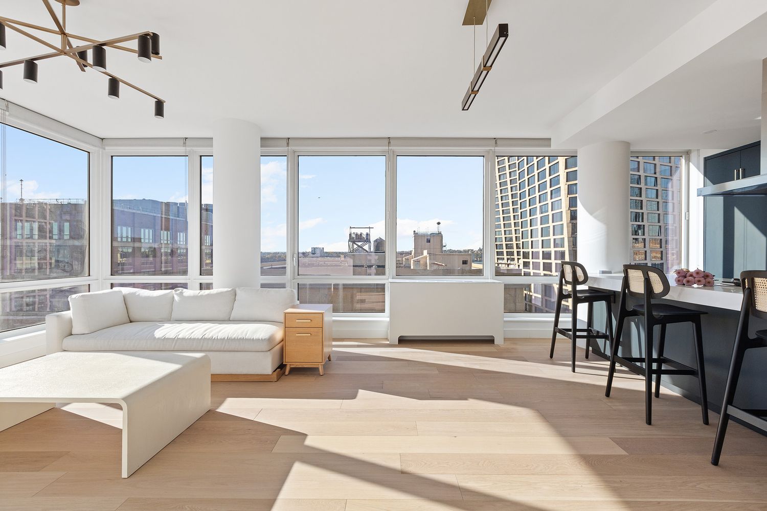 a living room with furniture and large windows