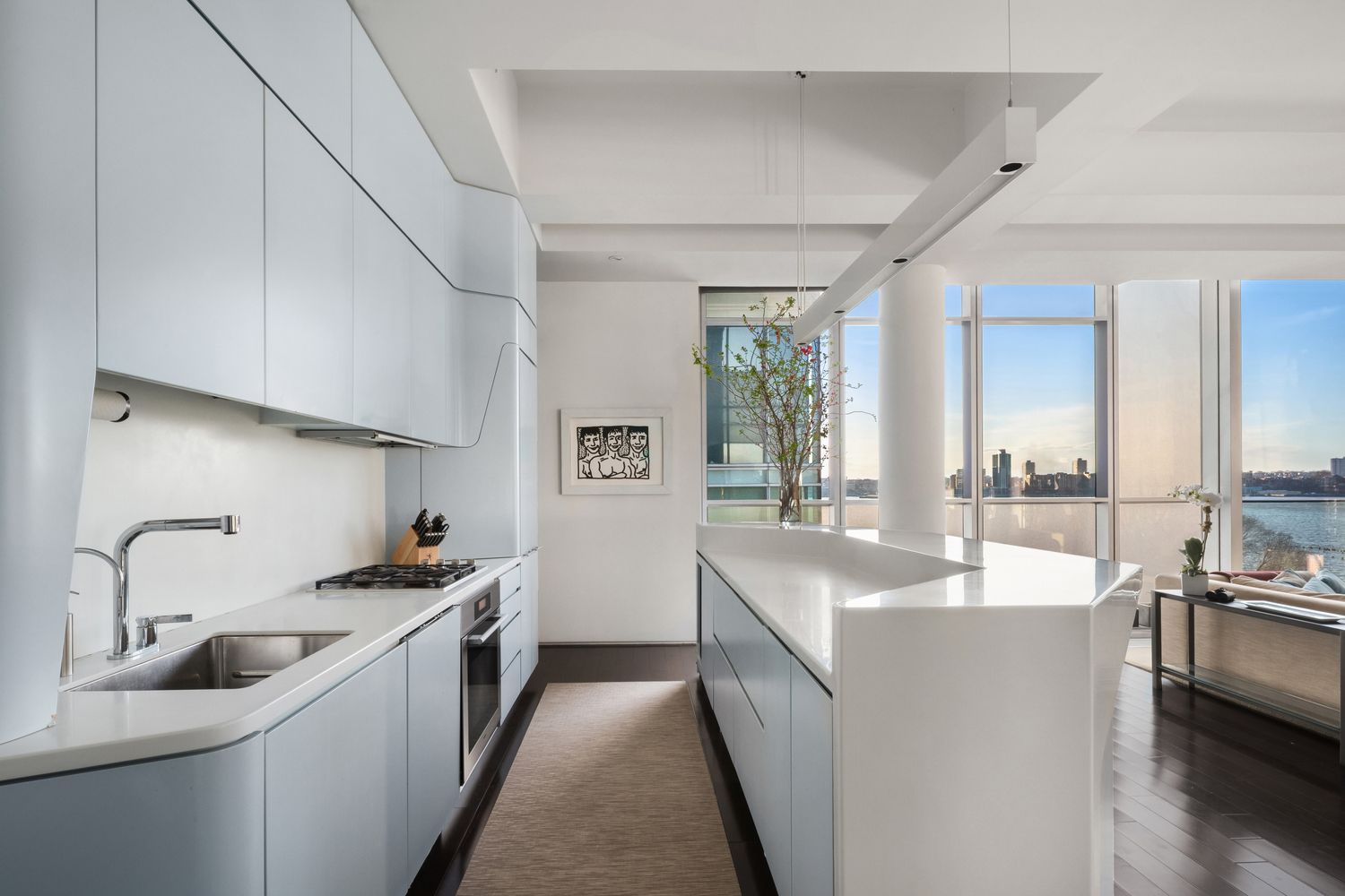 a view of a living room and kitchen floor to ceiling windows