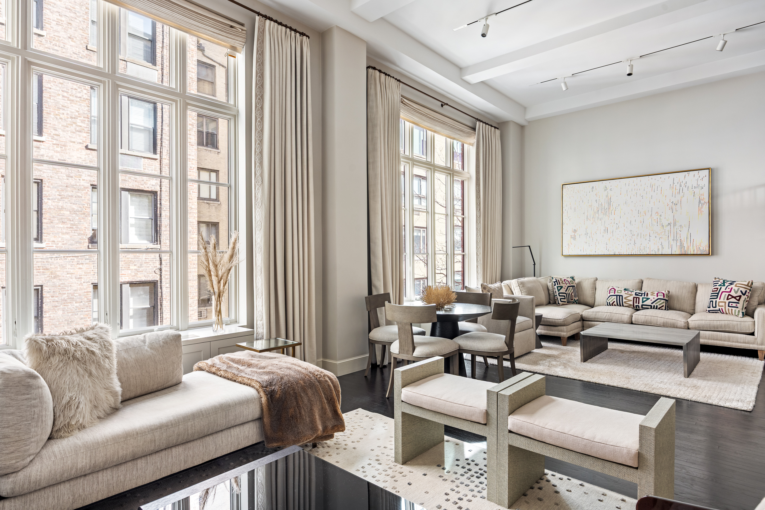 169 East 78th Street, Unit 7C Manhattan, NY 10075 - Photo 5 of 30 a living room with furniture and large windows