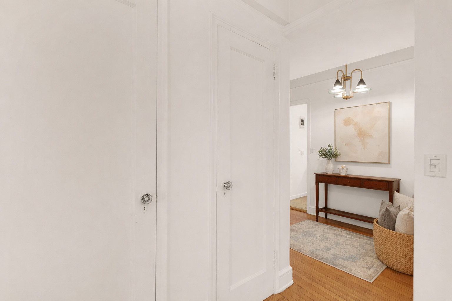 74 West 68th Street, Unit 5A Manhattan, NY 10023 - Photo 4 of 25 a view of an entryway with table and mirror