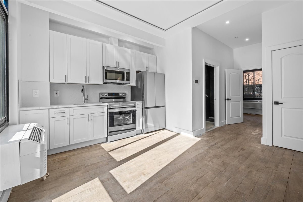 81 Suydam Street, Unit MULTI Brooklyn, NY 11221 - Photo 4 of 18 a kitchen with stainless steel appliances a refrigerator sink and cabinets