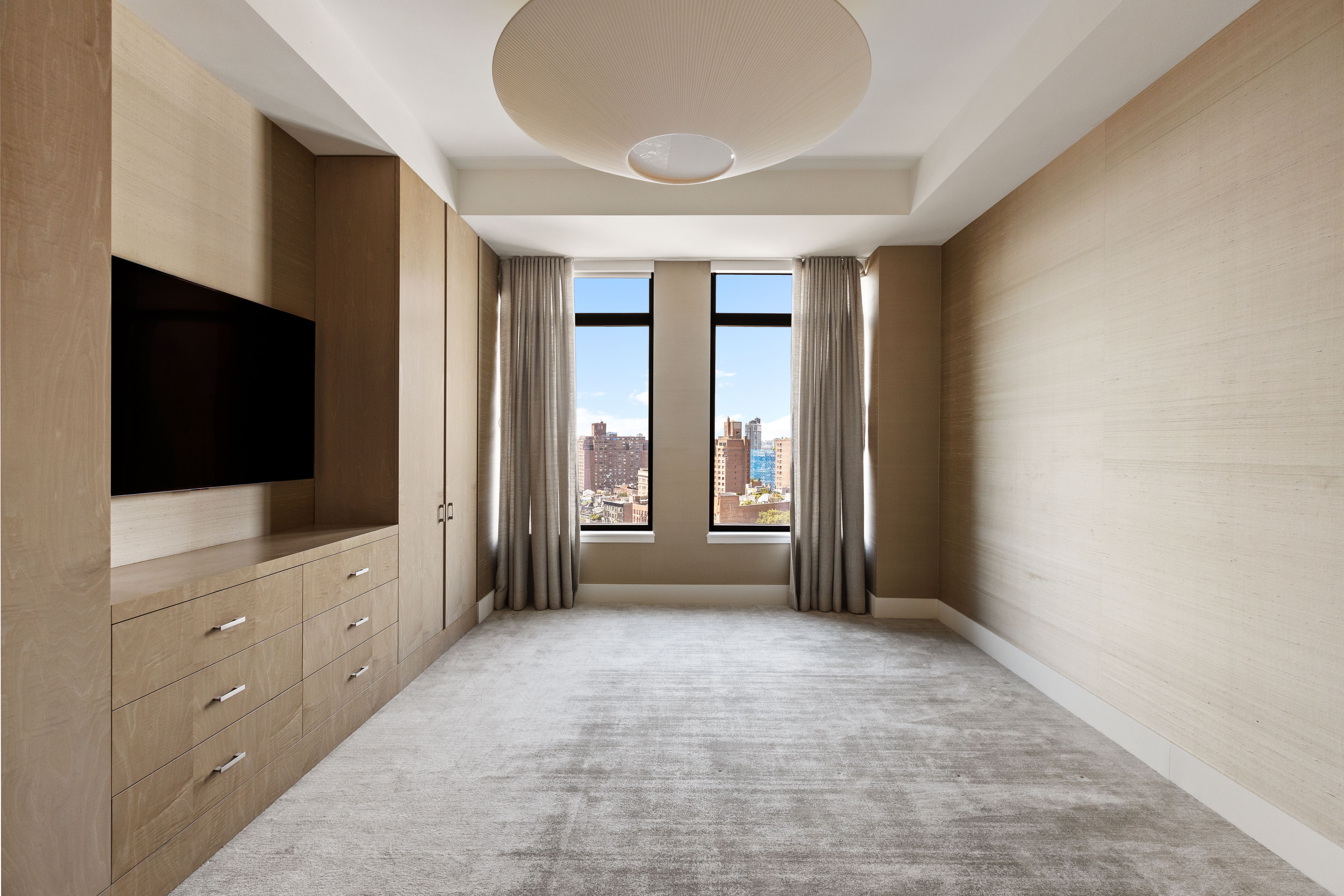 155 West 11th Street, Unit 14D Manhattan, NY 10011 - Photo 5 of 12 a view of an empty room with a window and a flat screen tv