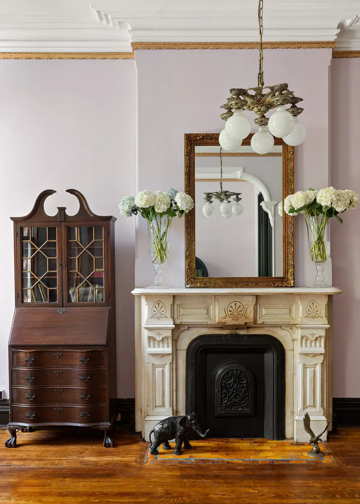 a living room with a fireplace furniture and a potted plant