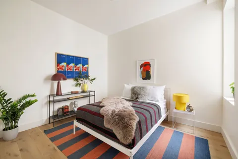 a bedroom with a bed and dresser