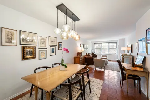 a view of a dining room with furniture and chandelier