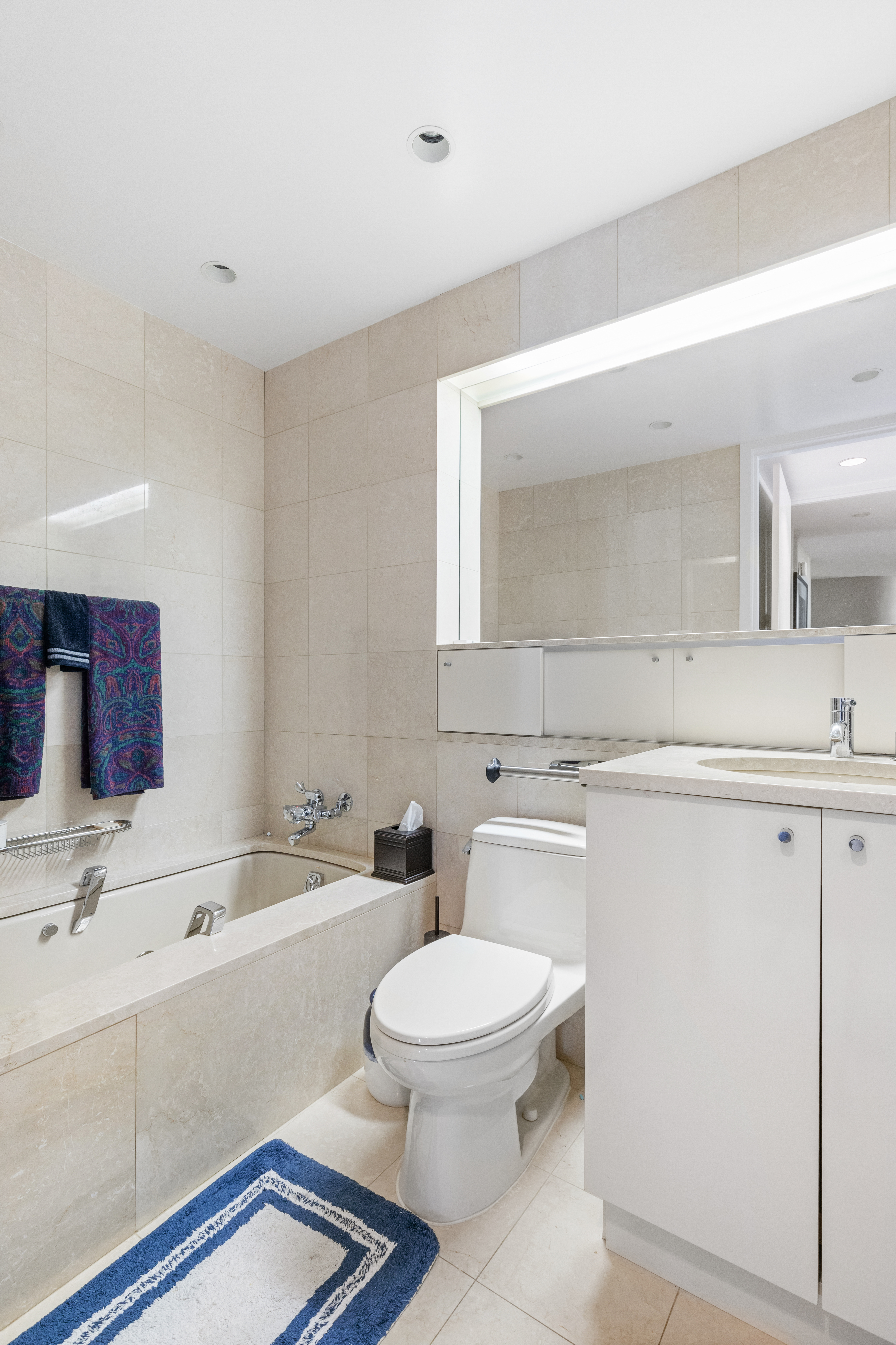 160 West 66th Street, Unit 42AB Manhattan, NY 10023 - Photo 9 of 15 a bathroom with a sink a toilet and a bathtub