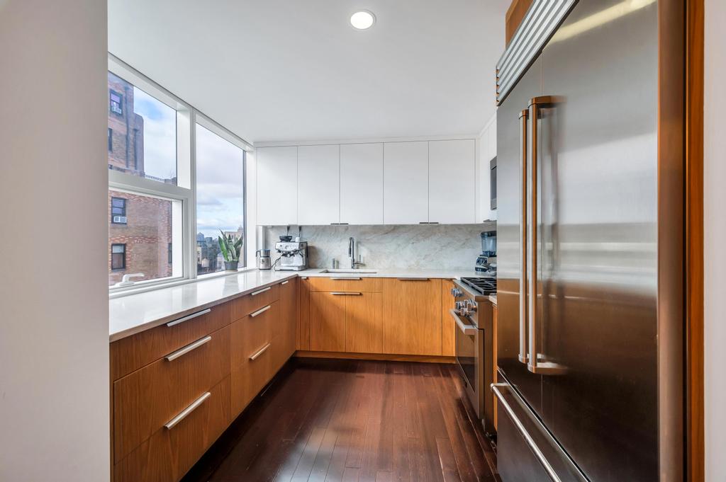 2628 Broadway, Unit 15B Manhattan, NY 10025 - Photo 8 of 21 a kitchen with stainless steel appliances granite countertop a refrigerator and a sink