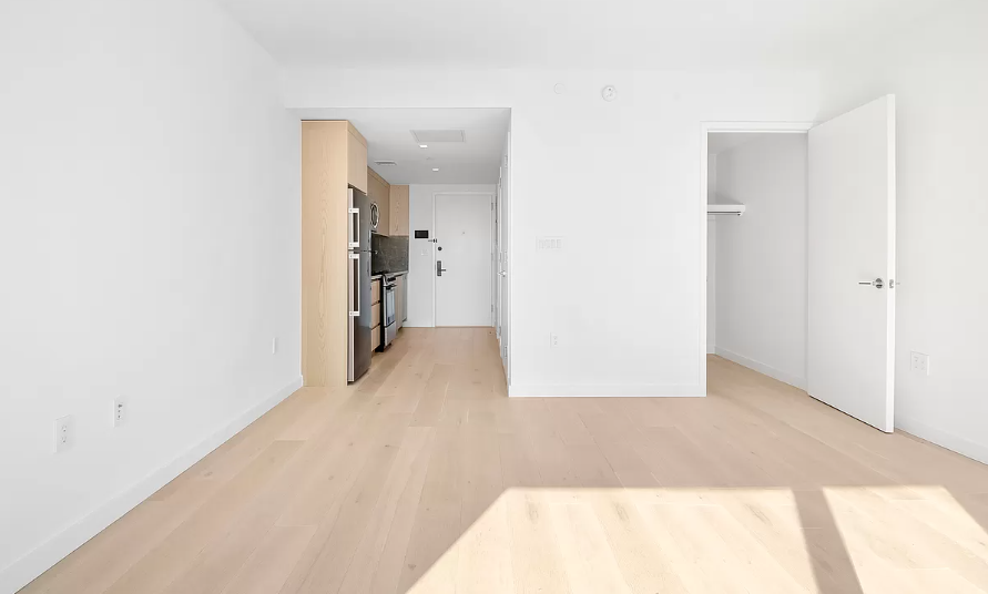 567 Ocean Avenue, Unit A607 Brooklyn, NY 11226 - Photo 2 of 12 a view of a hallway with wooden shelves