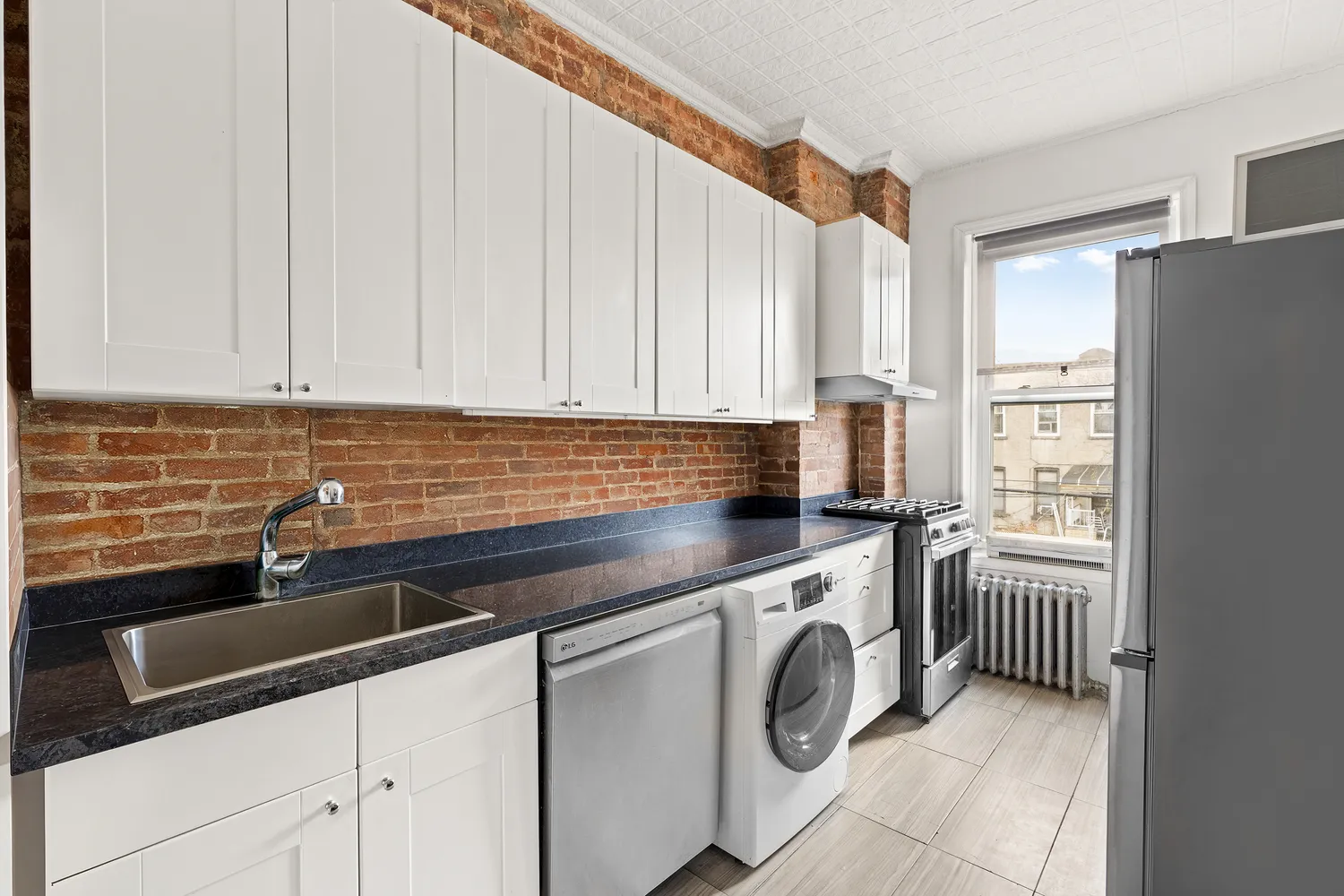 a kitchen with stainless steel appliances white cabinets and a sink