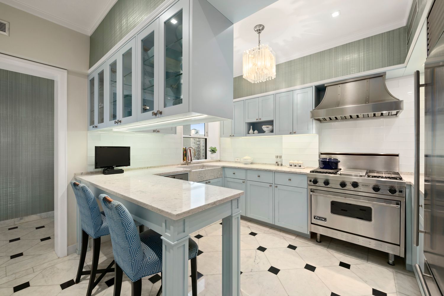 a kitchen with a stove a sink and a refrigerator