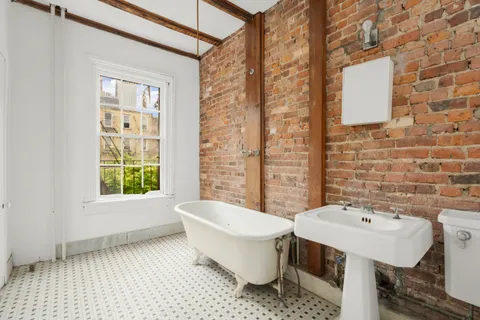 a bathroom with a sink toilet and mirror