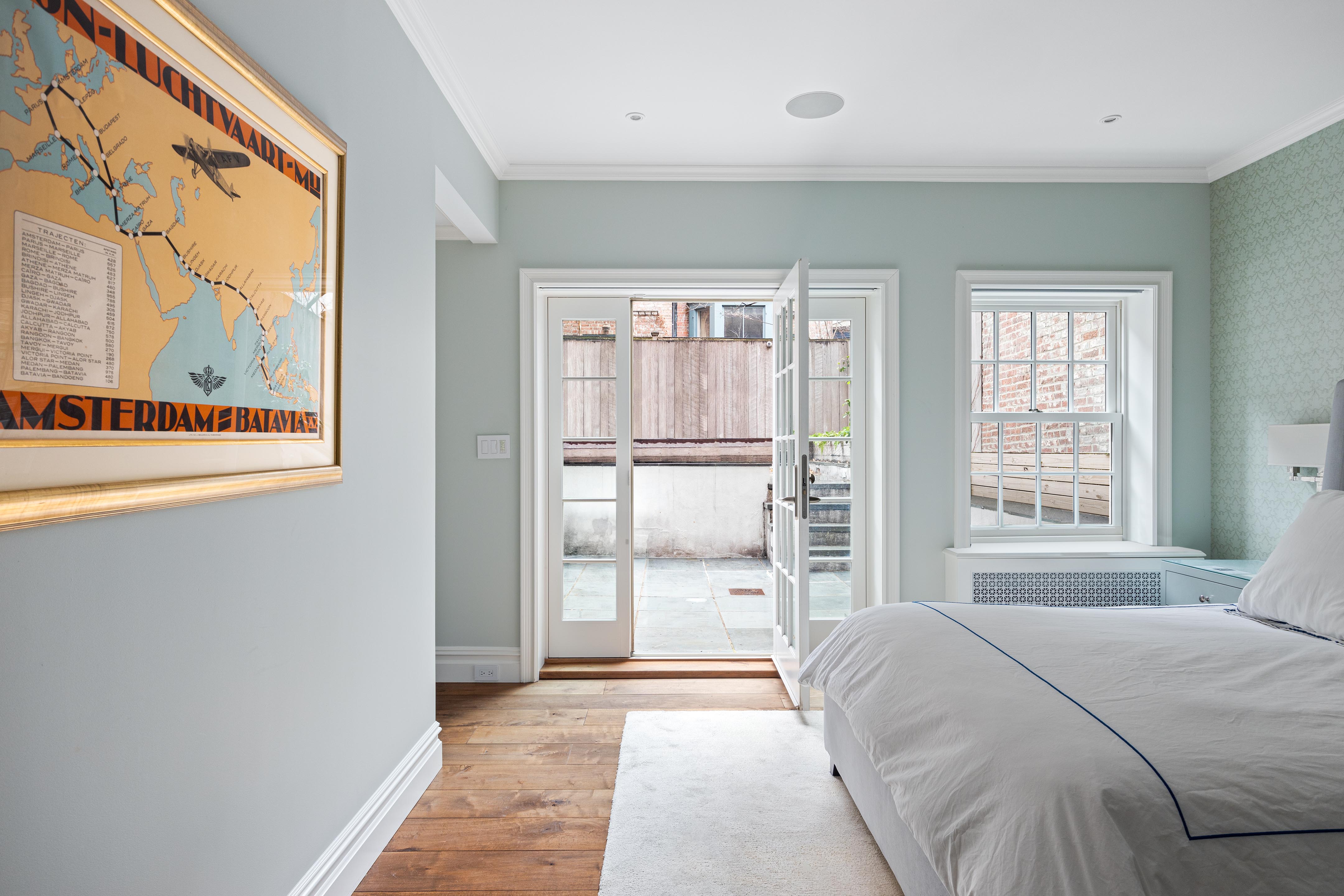 14 West 11th Street, Unit GARDEN Manhattan, NY 10011 - Photo 7 of 18 a spacious bedroom with a large bed and a large window
