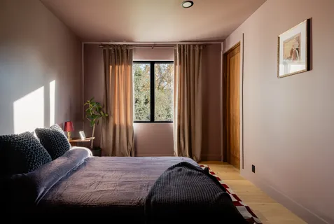 a view of swimming pool with seating area and trees in the background