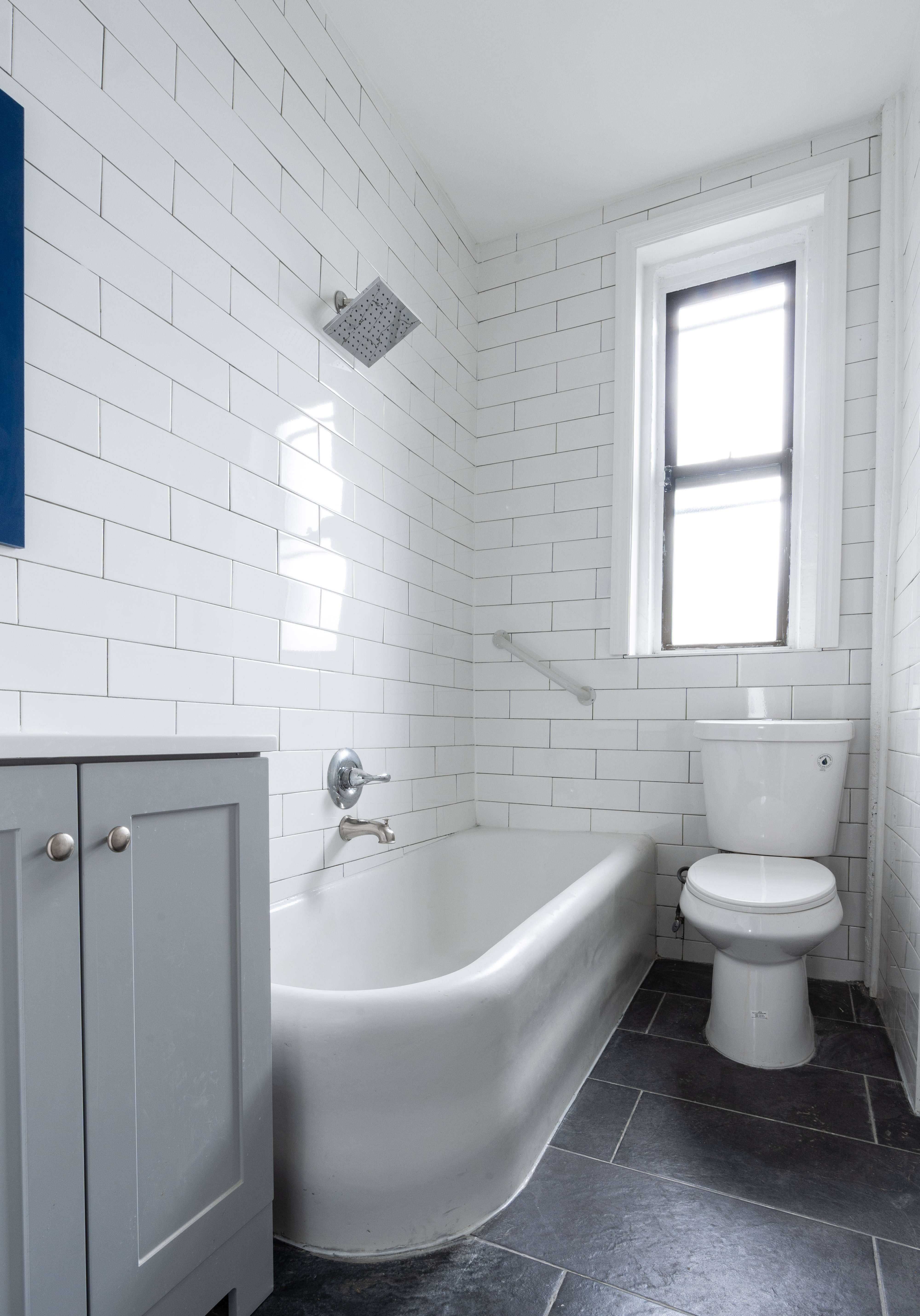 1405 Prospect Place, Unit B11 Brooklyn, NY 11213 - Photo 8 of 12 a bathroom with a white toilet sitting next to a window