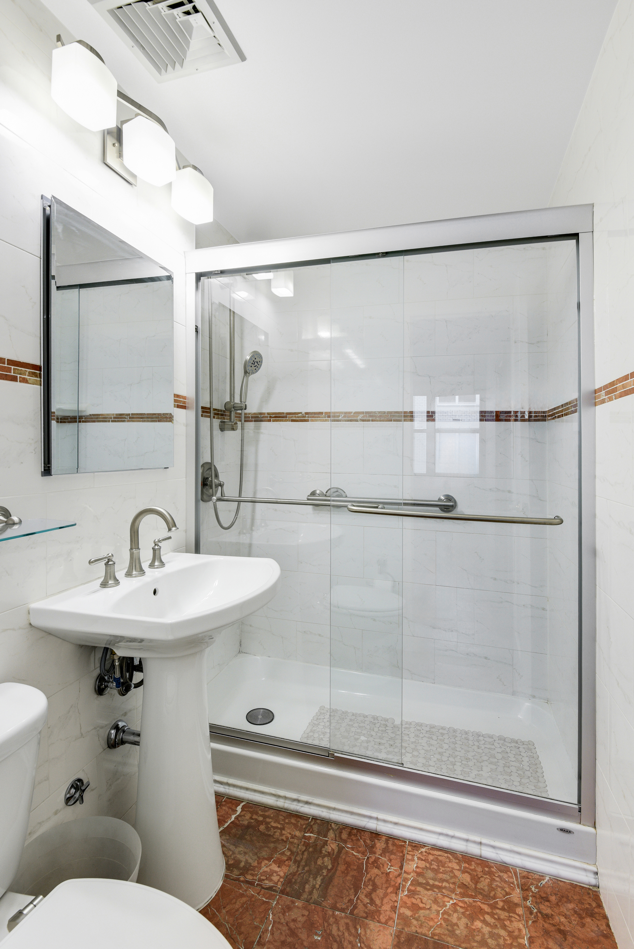 520 East 72nd Street, Unit 10P Manhattan, NY 10021 - Photo 12 of 13 a bathroom with a sink mirror and toilet