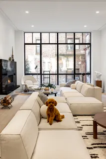 a bedroom with furniture and a large window