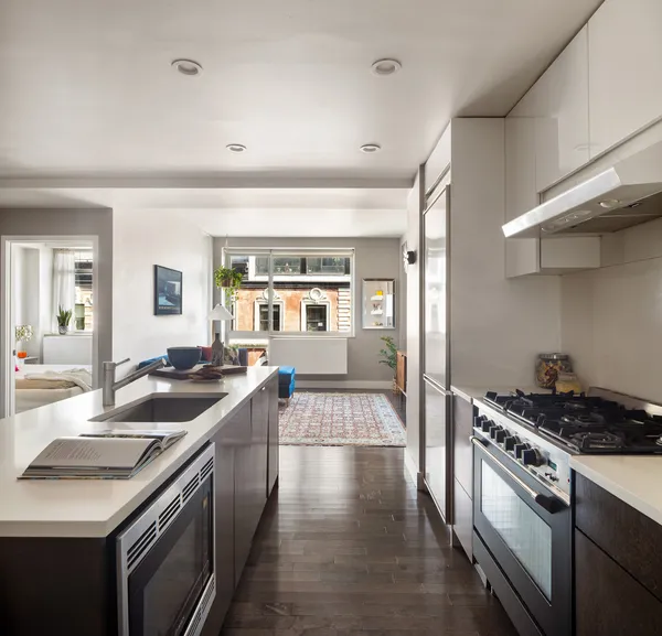 a kitchen with granite countertop a sink and stove