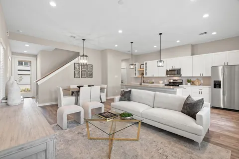 a living room with furniture and kitchen view