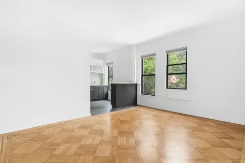 a view of a big room with windows and cabinet
