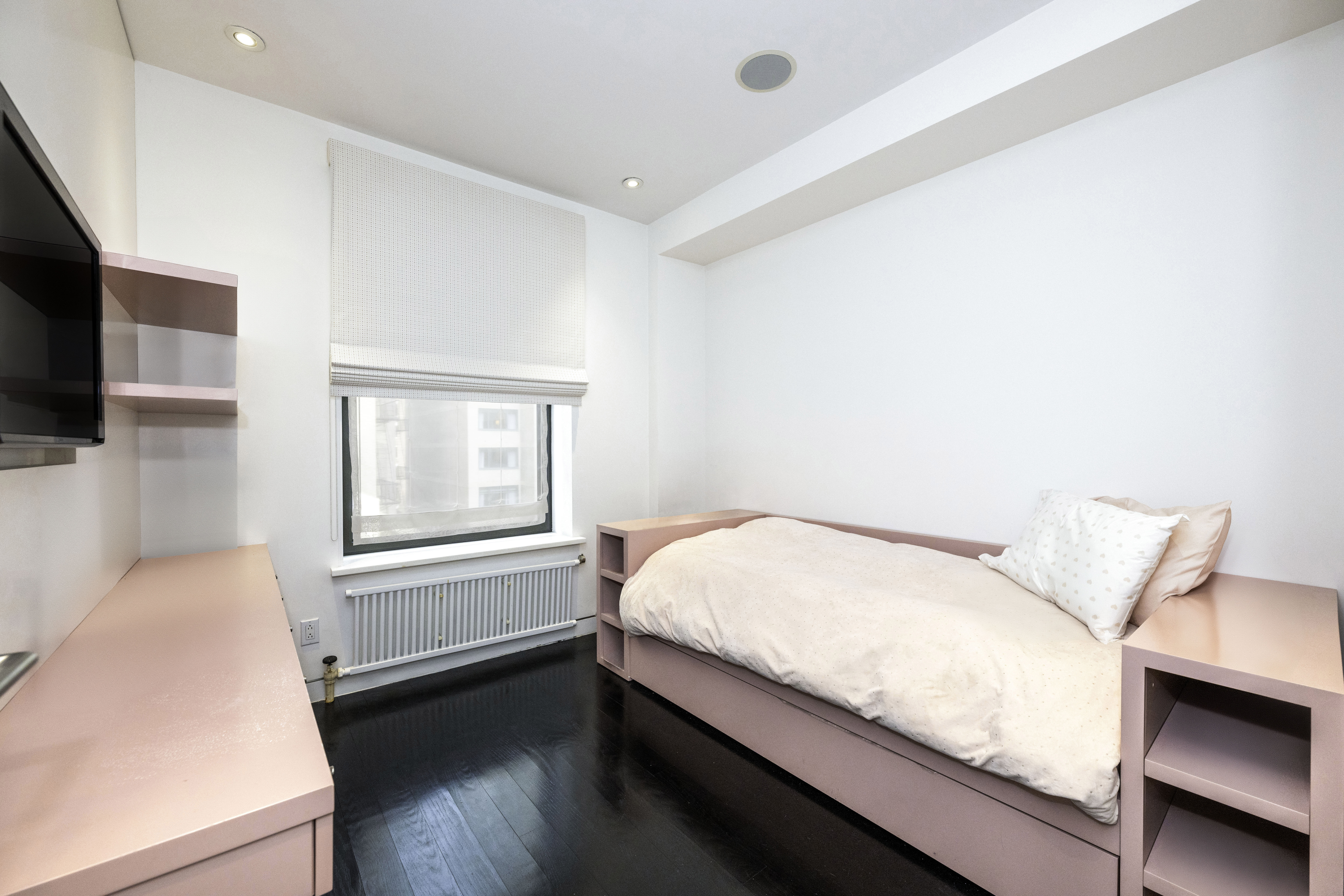 40 East 62nd Street, Unit 8E Manhattan, NY 10065 - Photo 19 of 24 a bed sitting in a bedroom next to a window