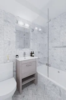 a bathroom with a sink a toilet and bathtub